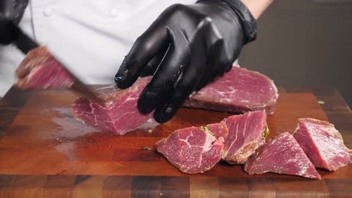 Chef Cuts Red Meat Into Smaller Pieces