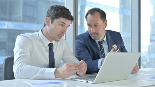 Men Discuss Project Together at Office Laptop