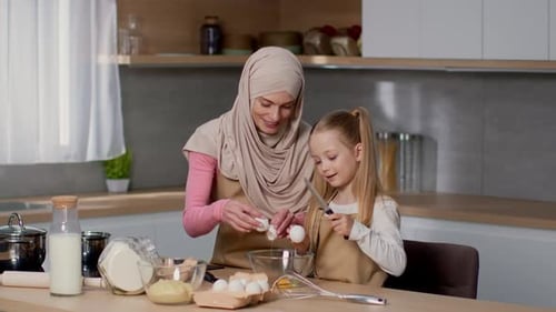Mother and Child Baking Together in Kitchen