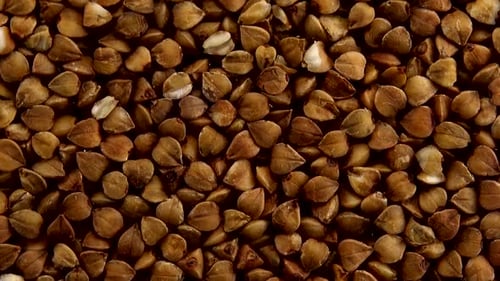 Buckwheat Groats Being Poured in Close Up