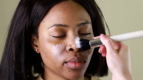 Woman having Make Up Applied to Face Close Up