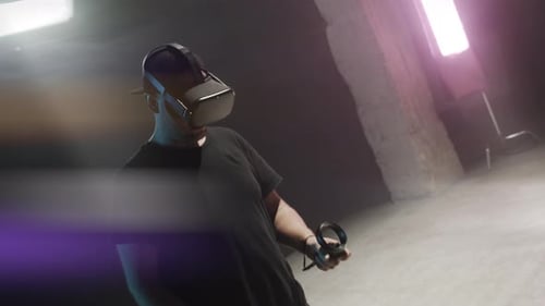 Man Wears VR Headset Holding Controllers