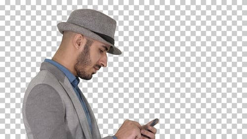 Serious Arabic Casual Man Using Smartphone While Walking Alpha