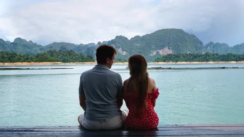 Back View of Happy Kissing Romantic Couple Sit Together on Date in Nature