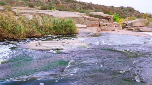 A Small Shining Stream Flows Among Smooth Wet and Dark Stones