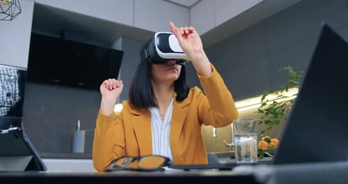Woman Using VR Headset at Kitchen Table