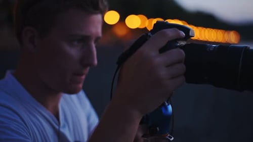 A Young Man Focusing Its Camera To Its Beautiful Subject In Italy At Night - Wide Shot