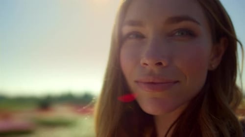 Blonde Woman Smiling in Sunny Field