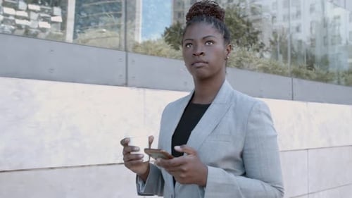 Businesswoman Checks Phone on Break