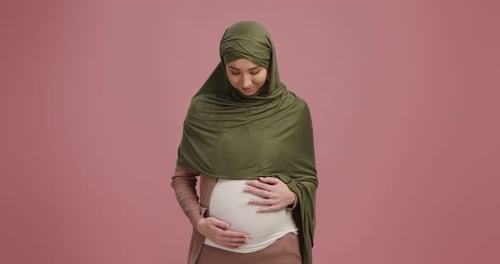 Young Pregnant Woman Holding Her Belly Indoors