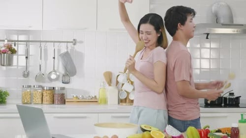 Energetic Couple Dances and Sings in Kitchen