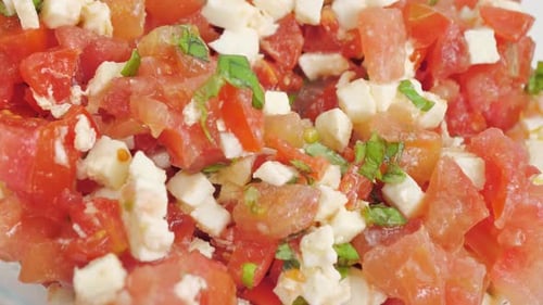 Close Up Shot of Basil Tomato Salad with Mozzarella Stir with Spoon