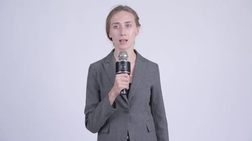 Woman Presenting with Microphone on White Background