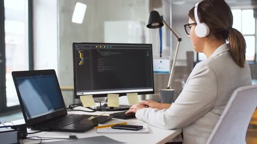 Woman Works at Computer in Modern Workplace