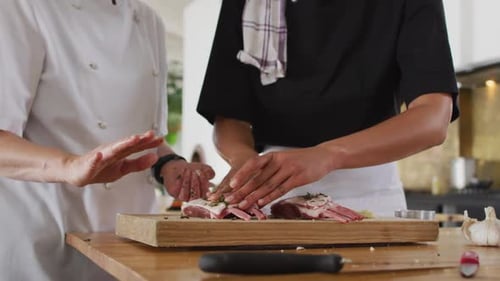 Chefs Preparing Meat in a Commercial Kitchen