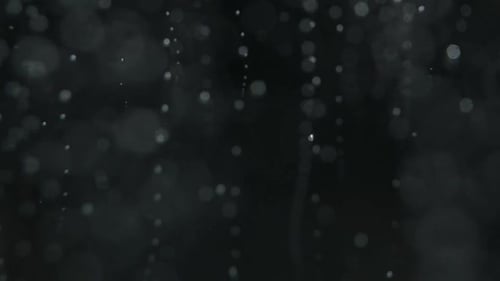 Abstract Particles Falling on Dark Background