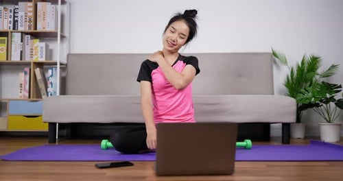 Woman Stretching Shoulder While Watching Laptop