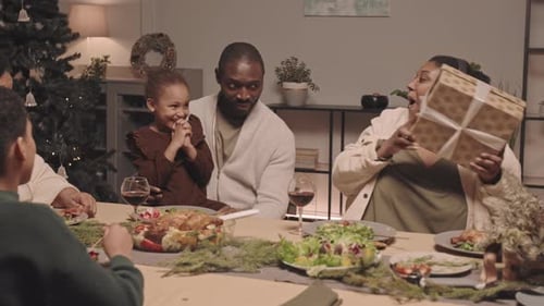 Family Celebrates with Gifts at Holiday Dinner