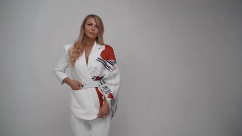 Beautiful Girl in a White Suit Posing at Camera