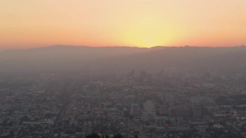 Aerial of orange sunset light on cityscape