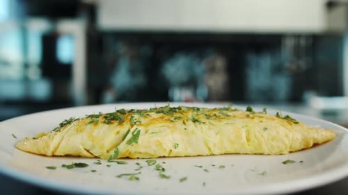 Close-up: French omelette with herbs in a professional kitchen