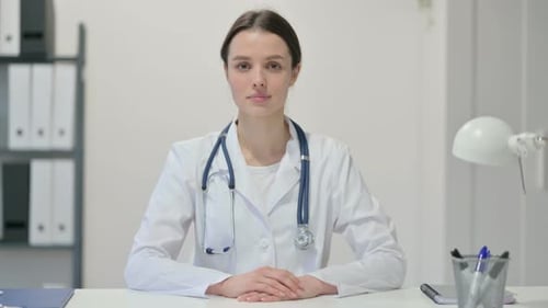 Female Doctor in White Coat in Hospital Office