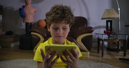 Child Using Smartphone in Home Living Room