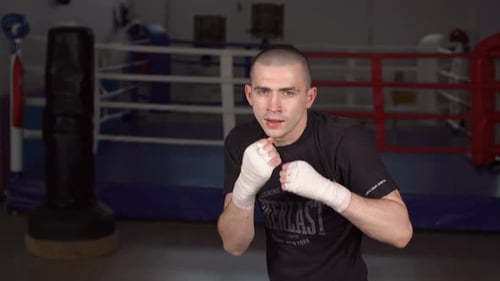 Man Training Boxing Punches in Gym