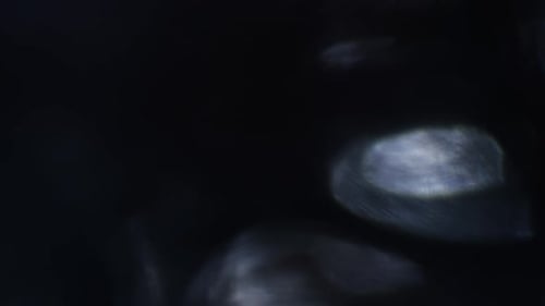Abstract Glowing Light Shimmers on Dark Background