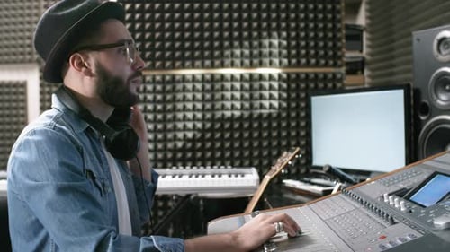 Audio Engineer Mixing Music in Recording Studio