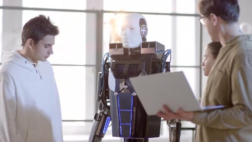 Engineers Developing Advanced Robot in Bright Studio