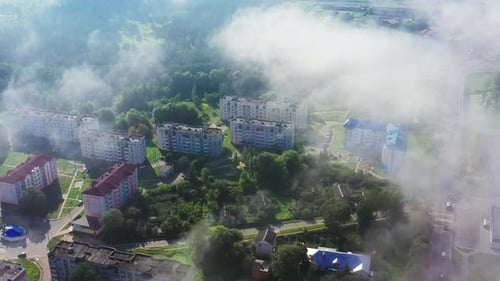 The City Is Buried in Spring Greenery and Morning Fog, Ecological Town From a Height of Flight