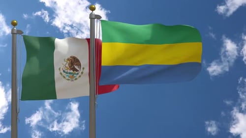 Mexican and Gabonese National Flags Waving on Flagpoles