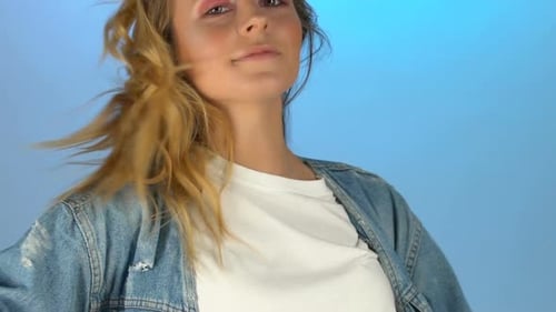 Blonde Woman in Denim Jacket Smiles and Winks