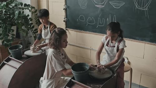 Children Learning Pottery in Classroom