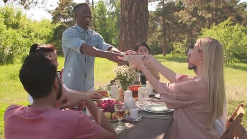 Friends Sharing a Meal Together in Nature