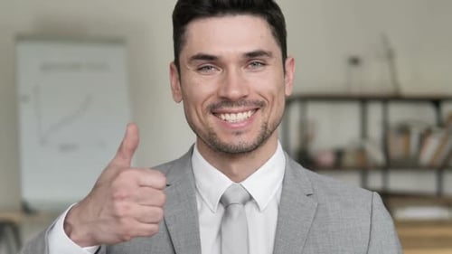 Man in Suit Gives Thumbs Up and Smiles