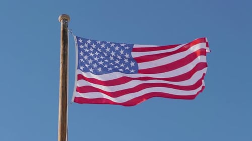 American Flag Waving in Clear Blue Sky