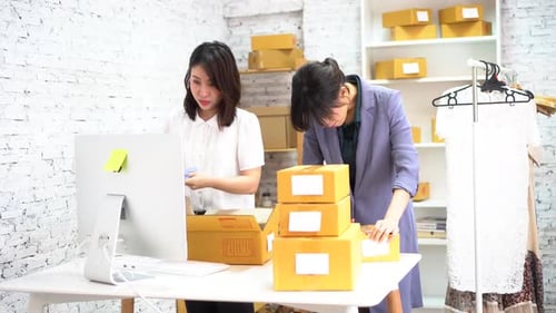 Women Packing Orders in Office Workplace