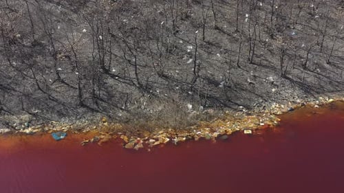 Polluted coastal area and red mine drainage lake 4K aerial footage