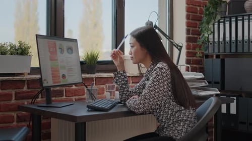 Pensive Worker Thinking About Business Strategy on Computer