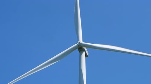 Electric windmill with long blades close-up. Wind turbine for the production of electricity.