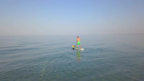 Aerial Drone View of a Man Paddling on a Sup Stand Board