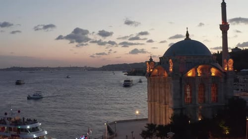 Beautifully Lit Ortakoy Mosque with Yellow Light on Bosphorus Riverside Revealing Incredible Sunset