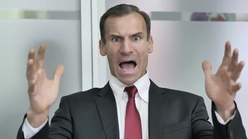 Man in Business Suit Shouts in Frustration