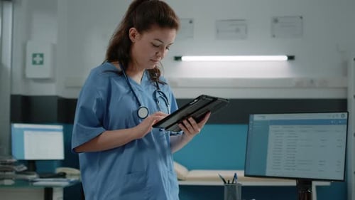 Woman Working As Nurse and Holding Digital Tablet
