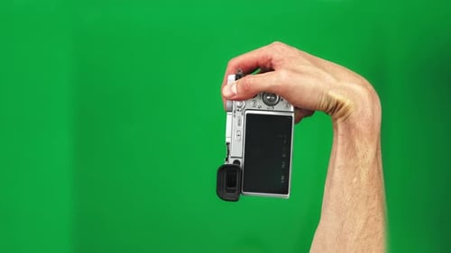 Set of 4 Gestures of Male Hands Holding Silver Photo Camera and Pushing Button on Green Screen
