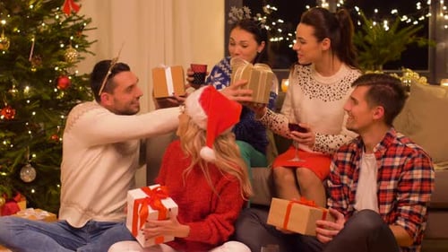 Friends Exchange Christmas Gifts in Cozy Home Setting