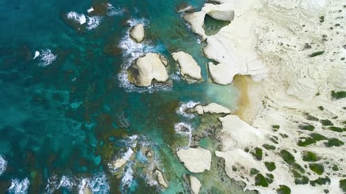Küstenstreifen Ozeanwellen spritzen gegen Strand mit Felsen Hintergrund Klippen im Meer Top Aerial
