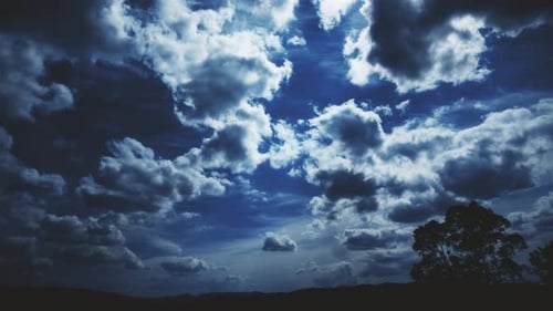 Dramatic Clouds Time Lapse Over Field and Tree